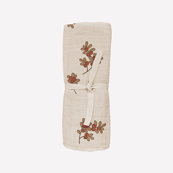 Lange bébé avec motif floral, enroulé et attaché par un ruban.