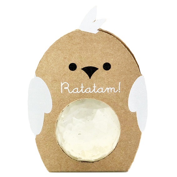 Balle rebondissante facettes oiseau dans un emballage en carton avec ailes blanches.