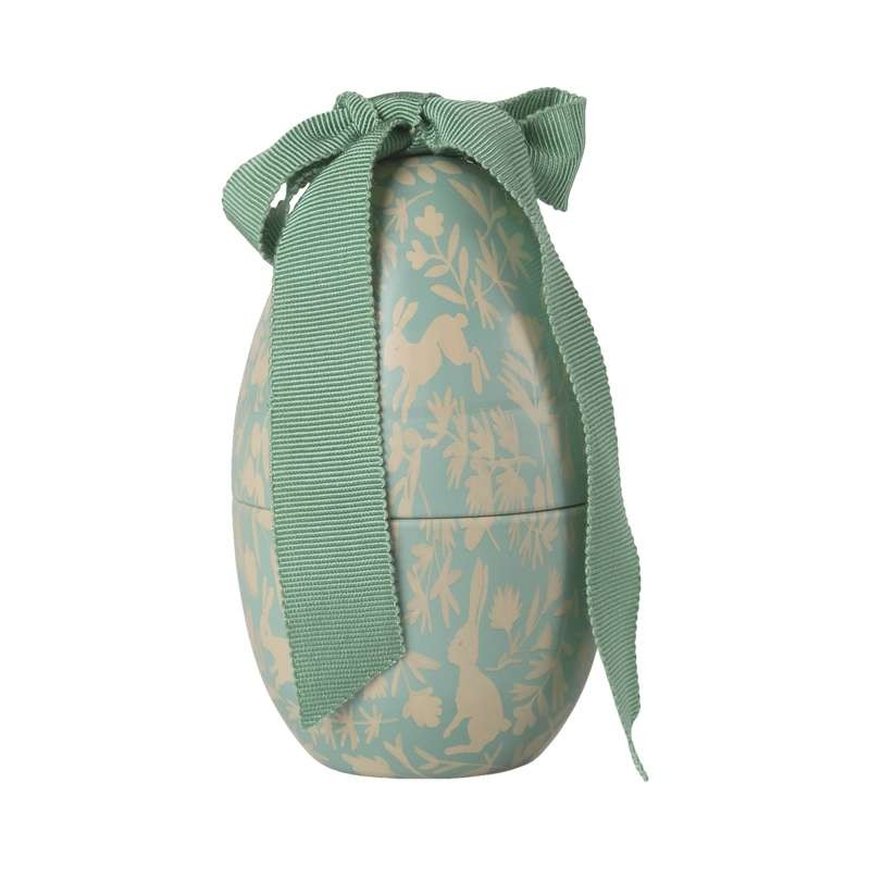 Petit œuf de Pâques avec motif de lapins et ruban vert, décoration festive
